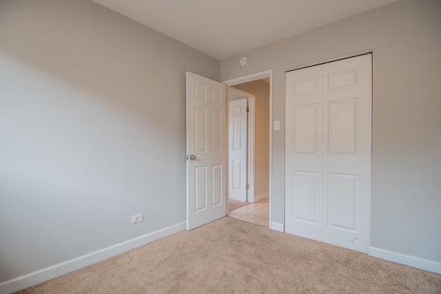 1344 Superior Ave, Calumet City, IL 60409 - unfurnished bedroom with baseboards, light carpet, and a closet