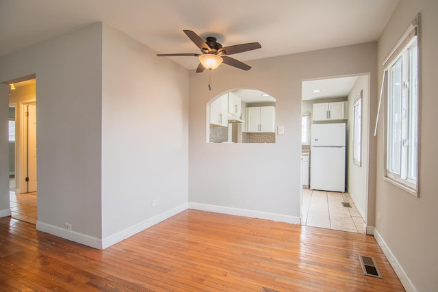1344 Superior Ave, Calumet City, IL 60409 - spare room featuring visible vents, baseboards, ceiling fan, and light wood finished floors