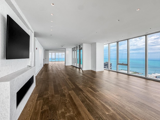 363 E Wacker Dr Unit 6306, Chicago, IL 60601 - unfurnished living room featuring wood finished floors, a fireplace, a wall of windows, a water view, and baseboards