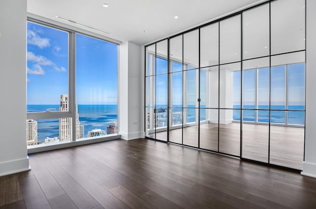 363 E Wacker Dr Unit 6306, Chicago, IL 60601 - spare room with floor to ceiling windows, a water view, and dark wood-type flooring