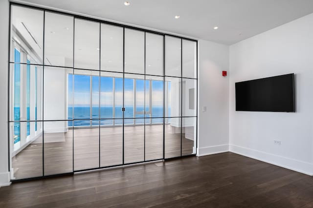 363 E Wacker Dr Unit 6306, Chicago, IL 60601 - unfurnished room featuring dark wood-style floors, baseboards, a wall of windows, and recessed lighting