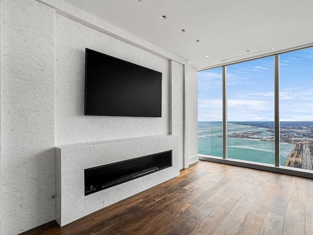 363 E Wacker Dr Unit 6306, Chicago, IL 60601 - unfurnished living room with floor to ceiling windows, a fireplace, hardwood / wood-style flooring, a textured wall, and recessed lighting