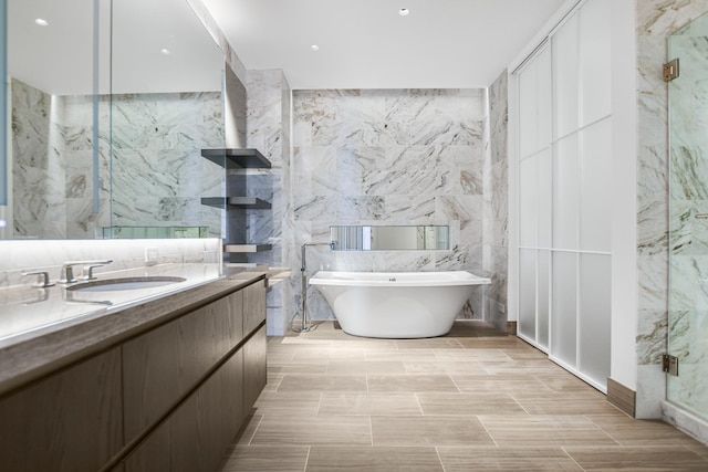 363 E Wacker Dr Unit 6306, Chicago, IL 60601 - bathroom featuring tile walls, vanity, a freestanding bath, and a marble finish shower