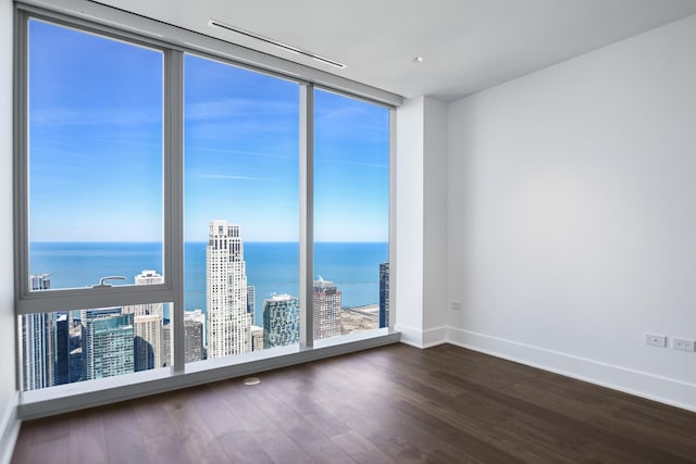 363 E Wacker Dr Unit 6306, Chicago, IL 60601 - empty room with floor to ceiling windows, a water view, dark wood-style flooring, and baseboards