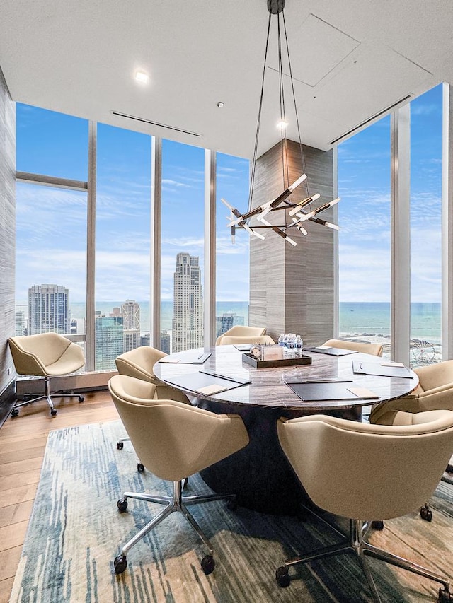 363 E Wacker Dr Unit 6306, Chicago, IL 60601 - dining room with a wall of windows, wood finished floors, healthy amount of natural light, a city view, and a water view