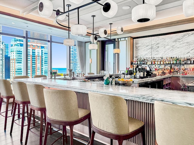 363 E Wacker Dr Unit 6306, Chicago, IL 60601 - indoor wet bar featuring a water view, wood finished floors, and decorative light fixtures
