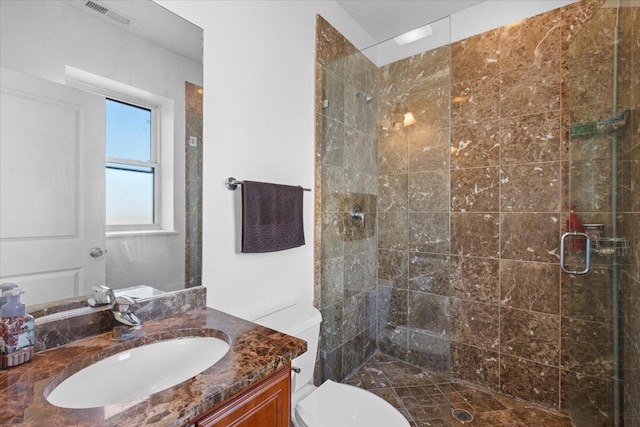 full bath featuring visible vents, toilet, a stall shower, and vanity