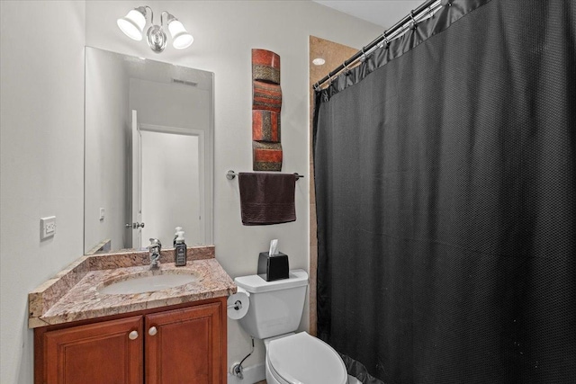 full bath with vanity, curtained shower, and toilet