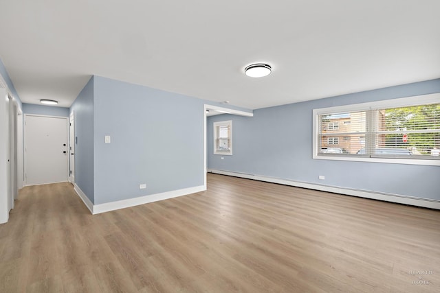 2411 W Balmoral Ave Unit 1F, Chicago, IL 60625 - empty room featuring light wood-type flooring and baseboard heating