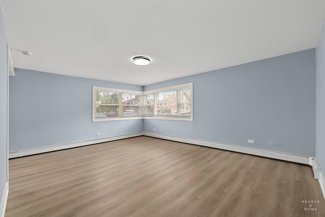 2411 W Balmoral Ave Unit 1F, Chicago, IL 60625 - unfurnished room with wood finished floors and a baseboard radiator
