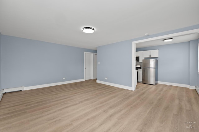 2411 W Balmoral Ave Unit 1F, Chicago, IL 60625 - unfurnished living room with light wood-type flooring and baseboards