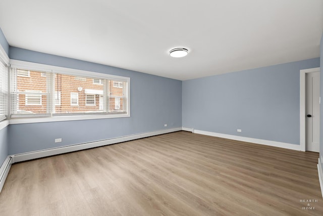 2411 W Balmoral Ave Unit 1F, Chicago, IL 60625 - empty room with wood finished floors and a baseboard heating unit