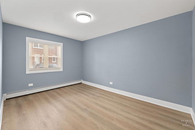 2411 W Balmoral Ave Unit 1F, Chicago, IL 60625 - unfurnished room featuring wood finished floors and a baseboard radiator