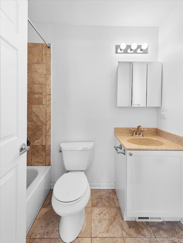 bathroom with baseboards, toilet, vanity, shower / tub combination, and tile patterned flooring