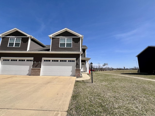 800 Sedgegrass Dr, Champaign, IL 61822 - view of front of home with driveway, a garage, brick siding, a front lawn, and board and batten siding
