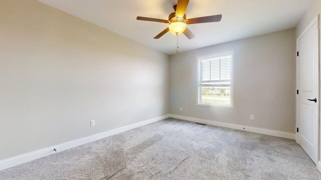 800 Sedgegrass Dr, Champaign, IL 61822 - carpeted empty room with a ceiling fan and baseboards