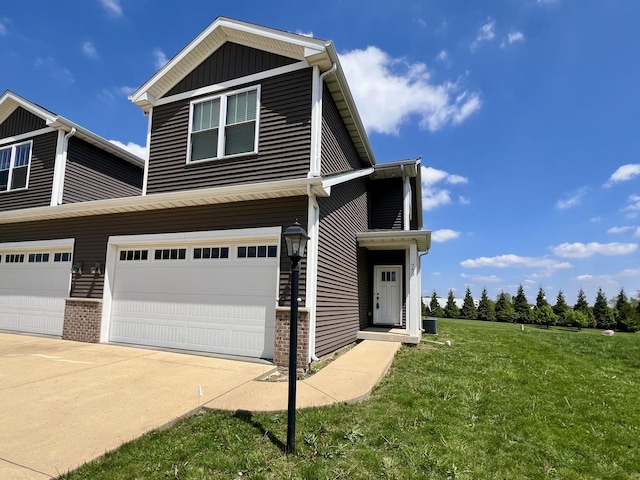 750 Sedgegrass Dr, Champaign, IL 61822 - view of front facade with a garage, a front lawn, brick siding, and driveway
