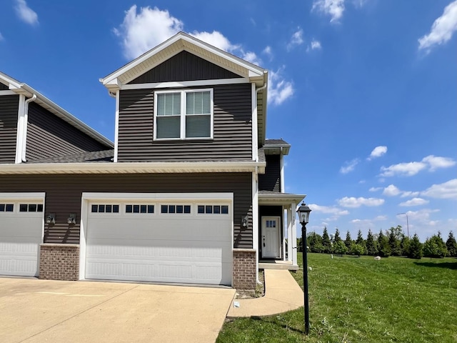 750 Sedgegrass Dr, Champaign, IL 61822 - view of front of property featuring a front yard, brick siding, driveway, and a garage