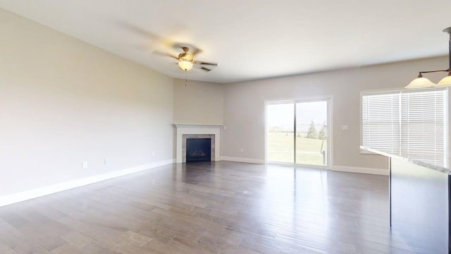 750 Sedgegrass Dr, Champaign, IL 61822 - unfurnished living room with a ceiling fan, wood finished floors, baseboards, and a fireplace