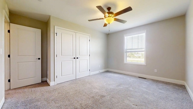 750 Sedgegrass Dr, Champaign, IL 61822 - unfurnished bedroom featuring carpet flooring, a closet, baseboards, and a ceiling fan