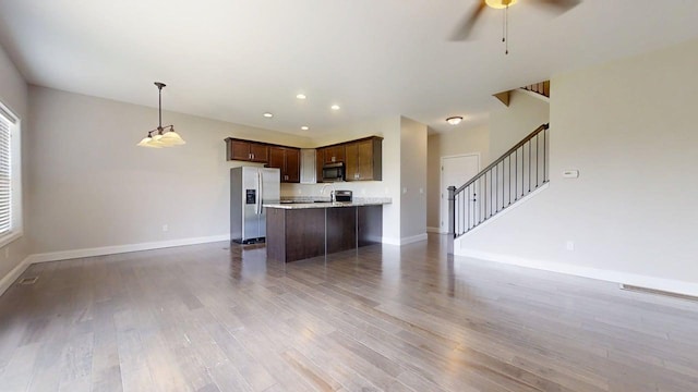 750 Sedgegrass Dr, Champaign, IL 61822 - unfurnished living room featuring baseboards, stairway, wood finished floors, a ceiling fan, and recessed lighting