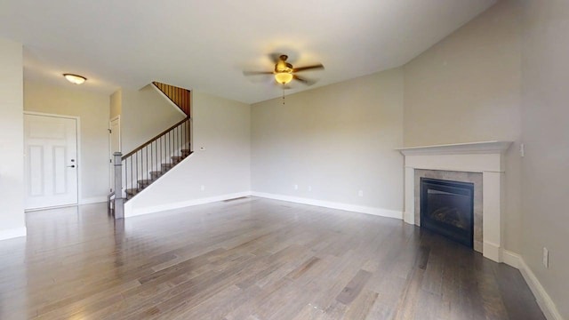 750 Sedgegrass Dr, Champaign, IL 61822 - unfurnished living room featuring ceiling fan, stairs, wood finished floors, a tiled fireplace, and baseboards