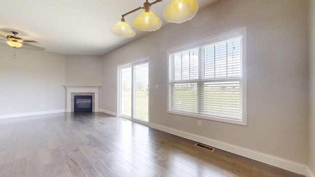 750 Sedgegrass Dr, Champaign, IL 61822 - unfurnished living room featuring baseboards, a tile fireplace, wood finished floors, and a ceiling fan