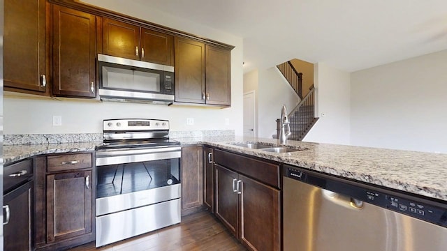 750 Sedgegrass Dr, Champaign, IL 61822 - kitchen featuring appliances with stainless steel finishes, a sink, dark wood-style floors, and light stone countertops