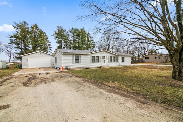 ranch-style house featuring a detached garage, metal roof, dirt driveway, an outbuilding, and a front lawn