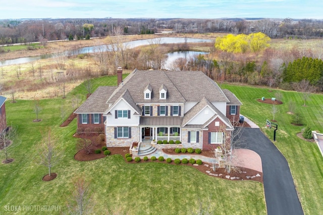 6 Shenandoah Cir S, Barrington, IL 60010 - view of front of house featuring a chimney, board and batten siding, a water view, stone siding, and a front yard