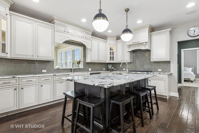 6 Shenandoah Cir S, Barrington, IL 60010 - kitchen with backsplash, glass insert cabinets, a kitchen bar, and a sink