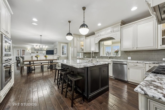 6 Shenandoah Cir S, Barrington, IL 60010 - kitchen with backsplash, a sink, appliances with stainless steel finishes, and dark wood-type flooring