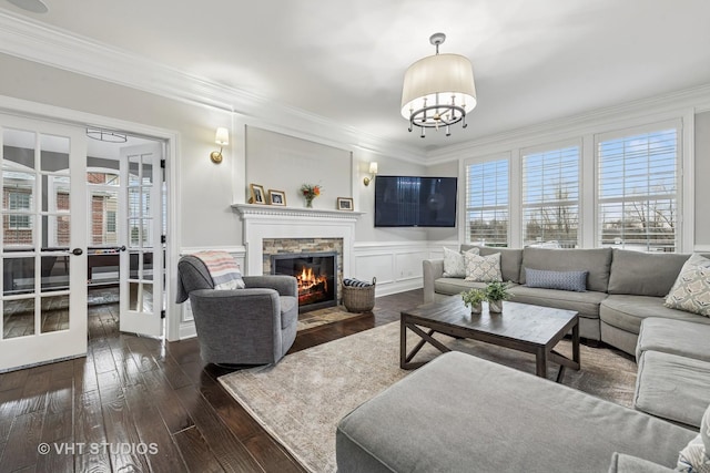 6 Shenandoah Cir S, Barrington, IL 60010 - living area with a fireplace, wood-type flooring, a notable chandelier, french doors, and crown molding