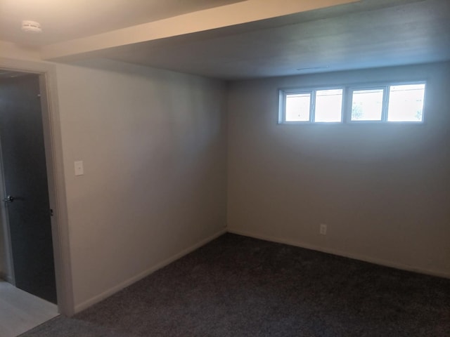 empty room featuring carpet flooring and baseboards