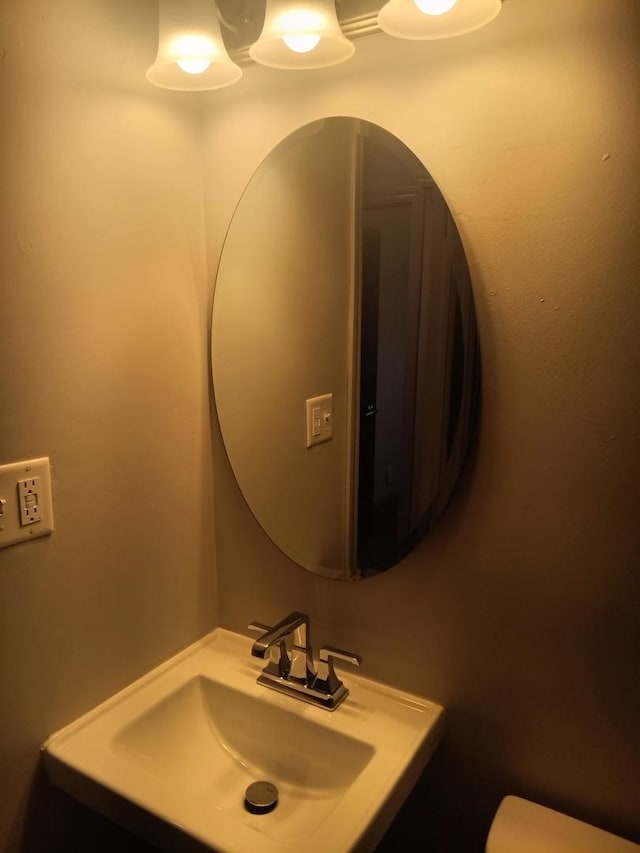 half bath with a sink and toilet
