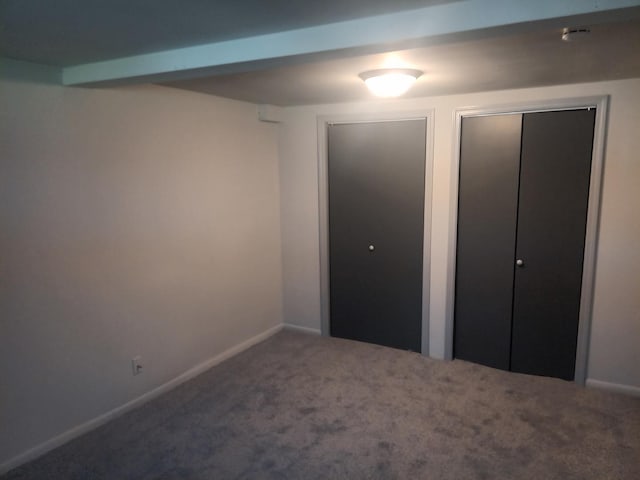 unfurnished bedroom featuring baseboards and carpet