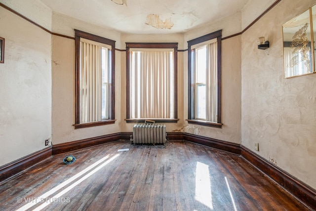 7206 S Champlain Ave, Chicago, IL 60619 - unfurnished room featuring radiator, healthy amount of natural light, wood-type flooring, and baseboards