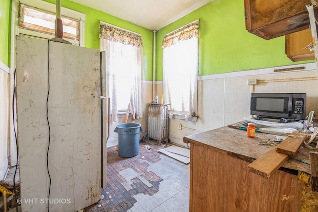 7206 S Champlain Ave, Chicago, IL 60619 - kitchen with radiator, wainscoting, and tile patterned floors