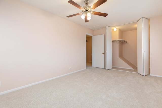 unfurnished bedroom with baseboards, light colored carpet, ceiling fan, and a closet