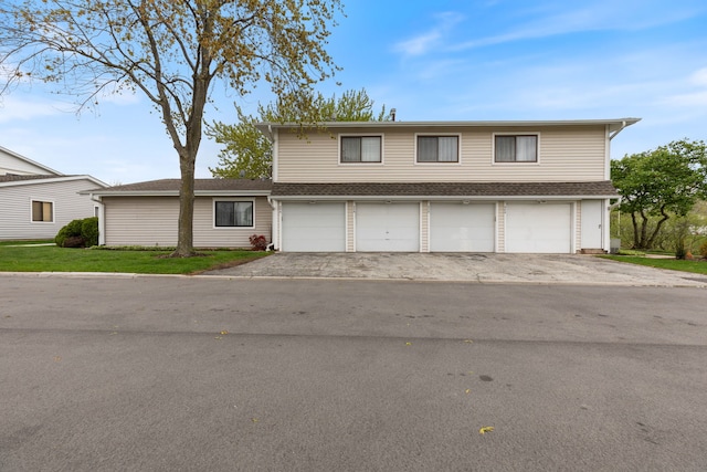traditional-style home with driveway and a garage