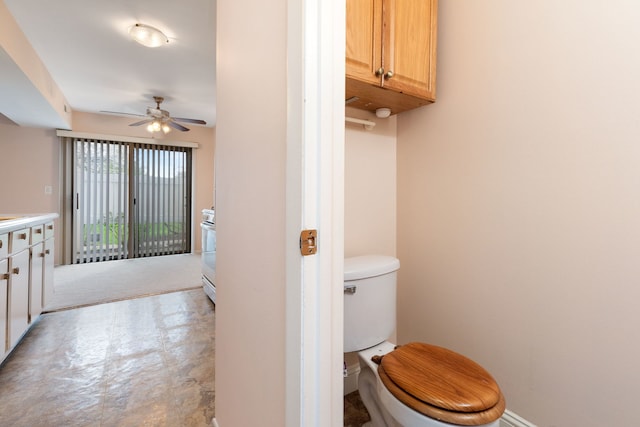 bathroom with ceiling fan and toilet