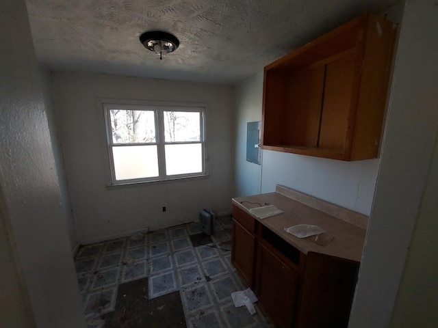 1616 S 7th St, Springfield, IL 62703 - kitchen with electric panel, tile patterned floors, a textured ceiling, and brown cabinetry