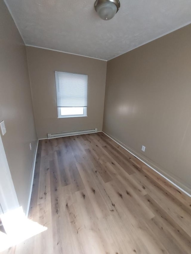 1616 S 7th St, Springfield, IL 62703 - empty room with baseboards, baseboard heating, and wood finished floors