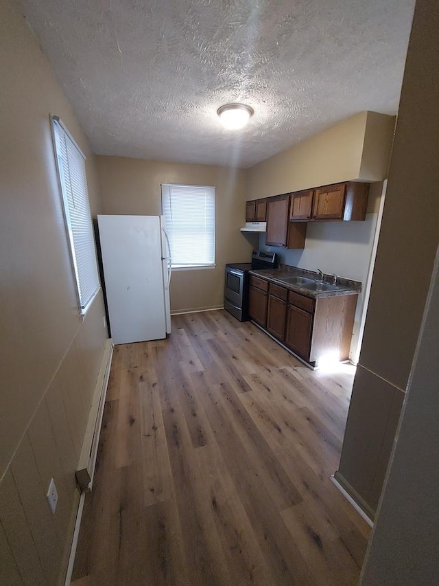 1616 S 7th St, Springfield, IL 62703 - kitchen with a baseboard radiator, dark countertops, a textured ceiling, electric range, and freestanding refrigerator