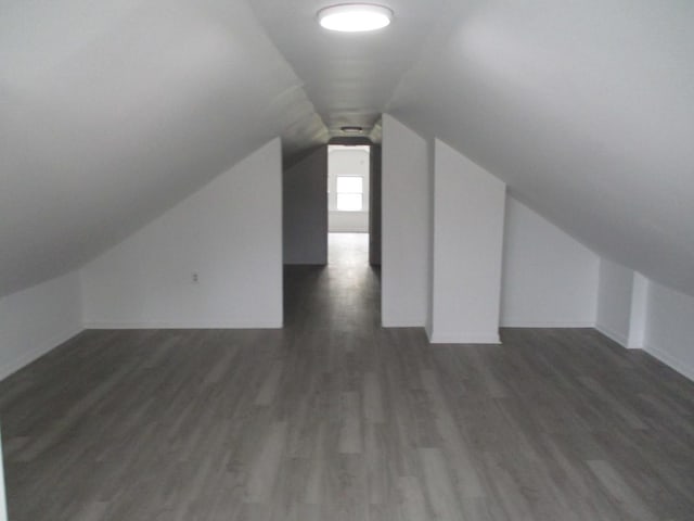 bonus room featuring wood finished floors, lofted ceiling, and baseboards