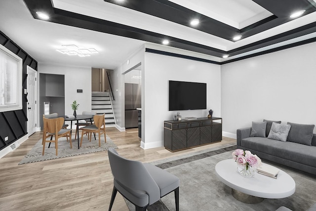 1158 W 111th St, Chicago, IL 60643 - living room featuring a tray ceiling, light wood-style flooring, baseboards, and stairs