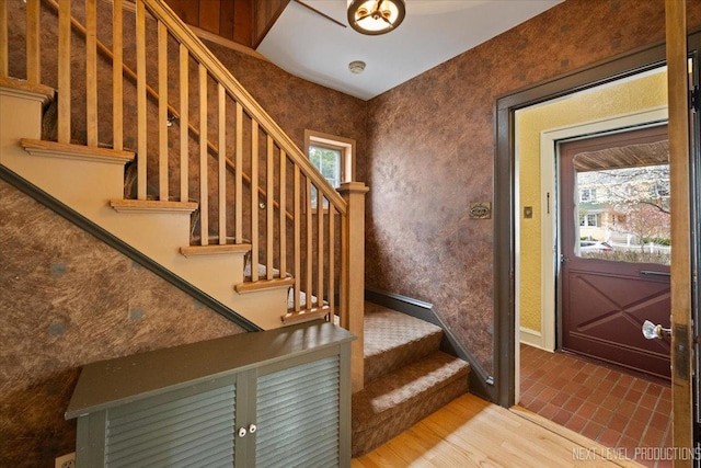 interior space featuring baseboards, wood finished floors, and stairs