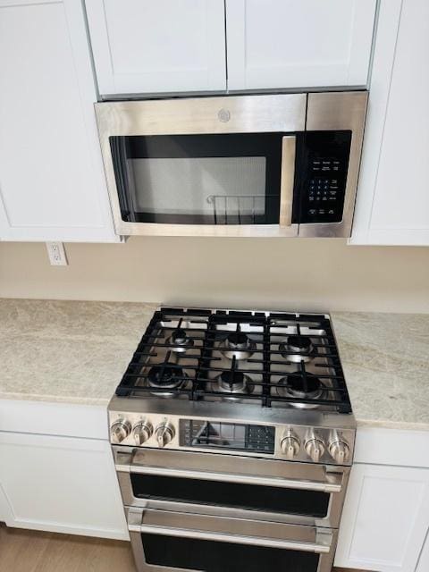 1507 7th St, Winthrop Harbor, IL 60096 - kitchen view of stainless steel appliances, light countertops, and white cabinets