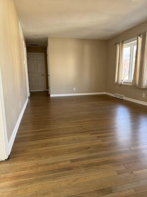 1507 7th St, Winthrop Harbor, IL 60096 - unfurnished room with dark wood-type flooring and baseboards
