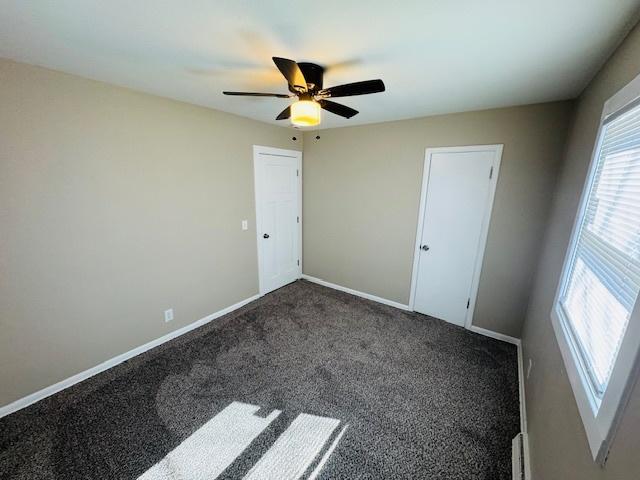 1507 7th St, Winthrop Harbor, IL 60096 - unfurnished bedroom featuring dark colored carpet and a ceiling fan